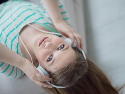 girl enjoying music through headphones